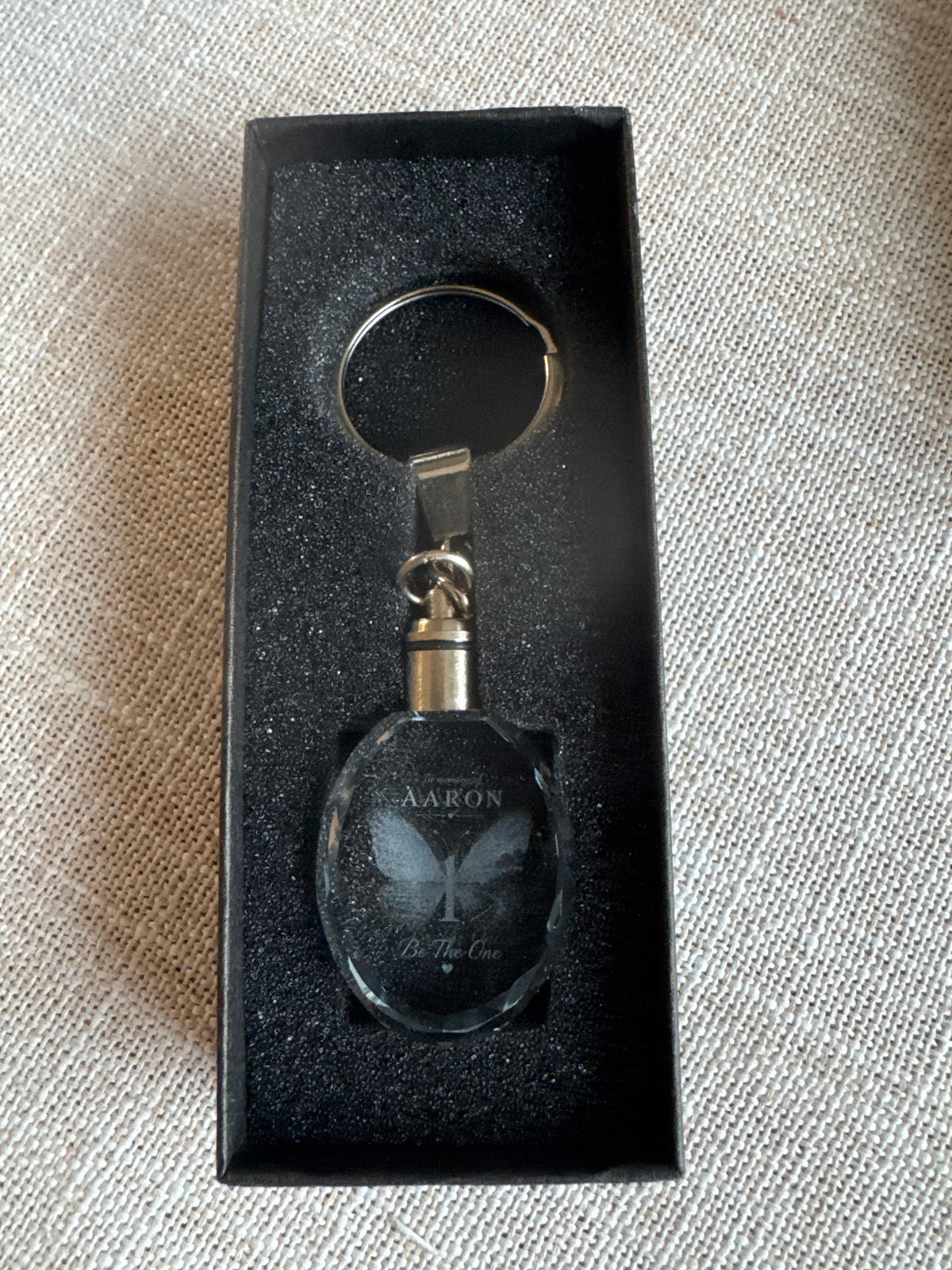 Unlit oval Be The One memorial keychain in its presentation box